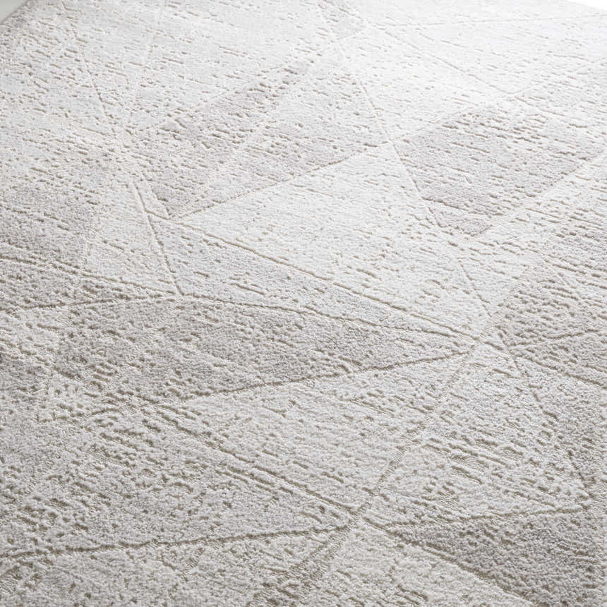 Close-up of the Basia Area Rug, gray and light gray geometric pattern, soft texture. Texture