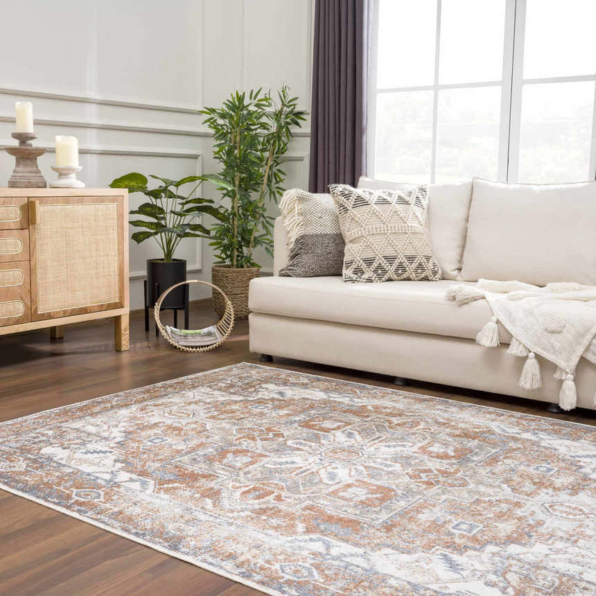 Living room with a Rust Hera Washable Area Rug, off-white sofa, wood cabinet, and plants for a vintage, farmhouse style. Roomscene-Rectangle