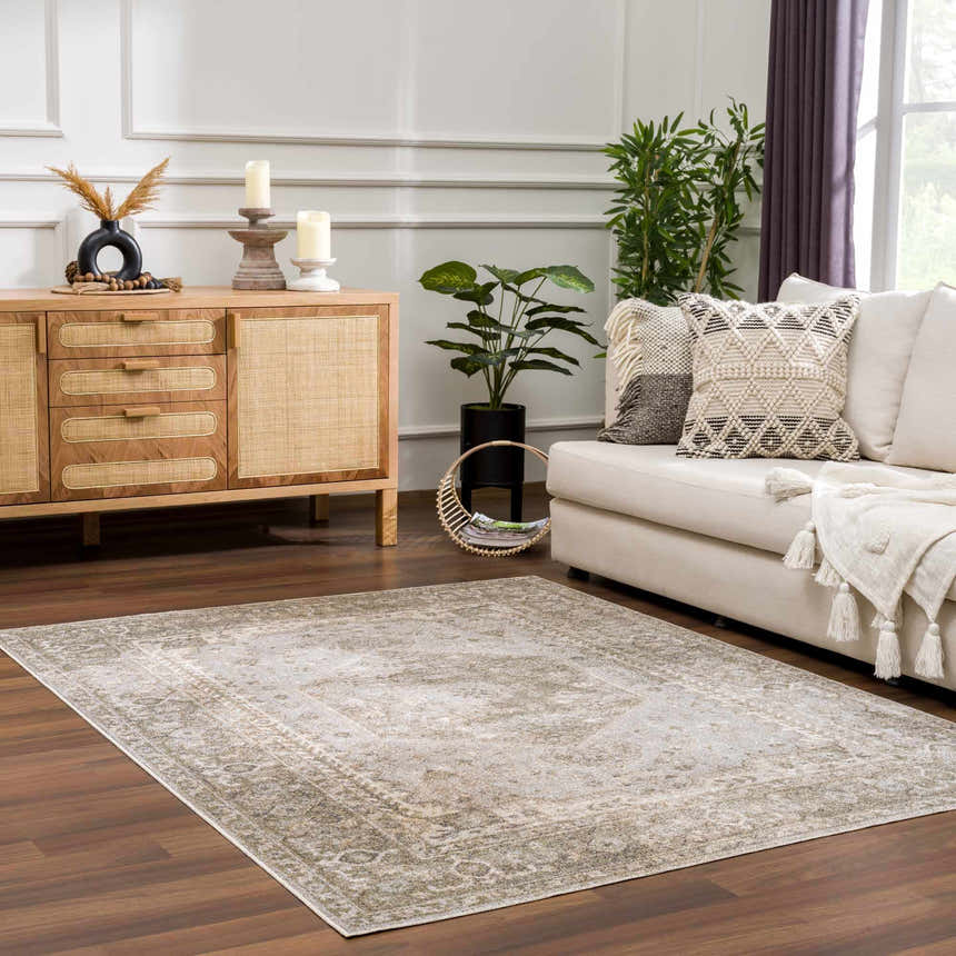 Living room scene with neutral sofa and Gael Boutique Washable Rug in light blue, olive, tan, and yellow. Farmhouse style. Roomscene-Rectangle