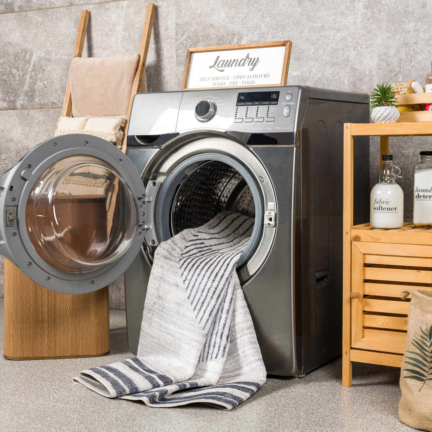 Laundry room scene with a Thad Medium Gray Washable Area Rug being washed in a front load washing machine. Washing-Machine