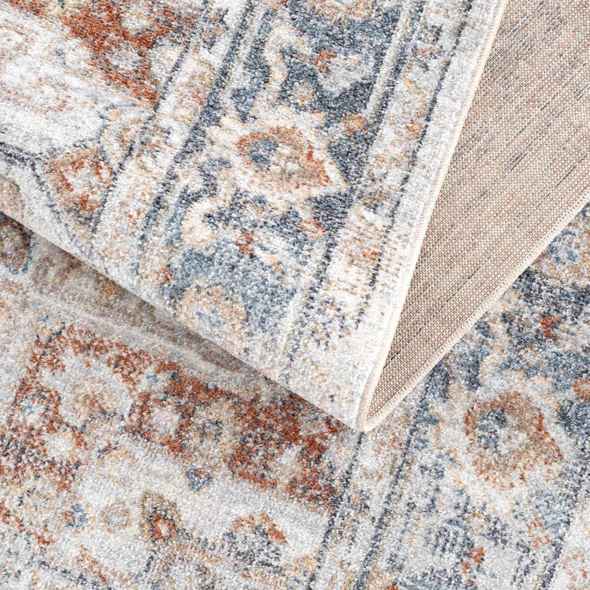 Close-up of the Neta Red & Blue Flat Pile Washable Rug showing its traditional, vintage pattern and flat weave texture. Fold