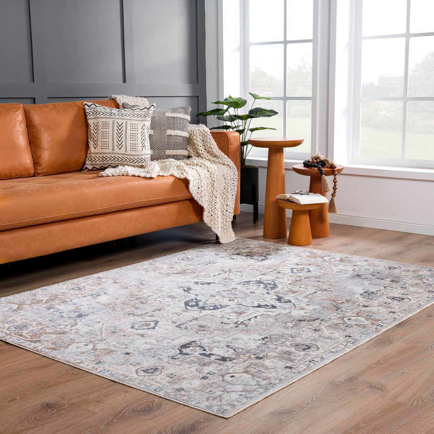 Living room with tan leather sofa and Dobry Boutique Washable Rug in blue, off white, and tan. Roomscene-Rectangle
