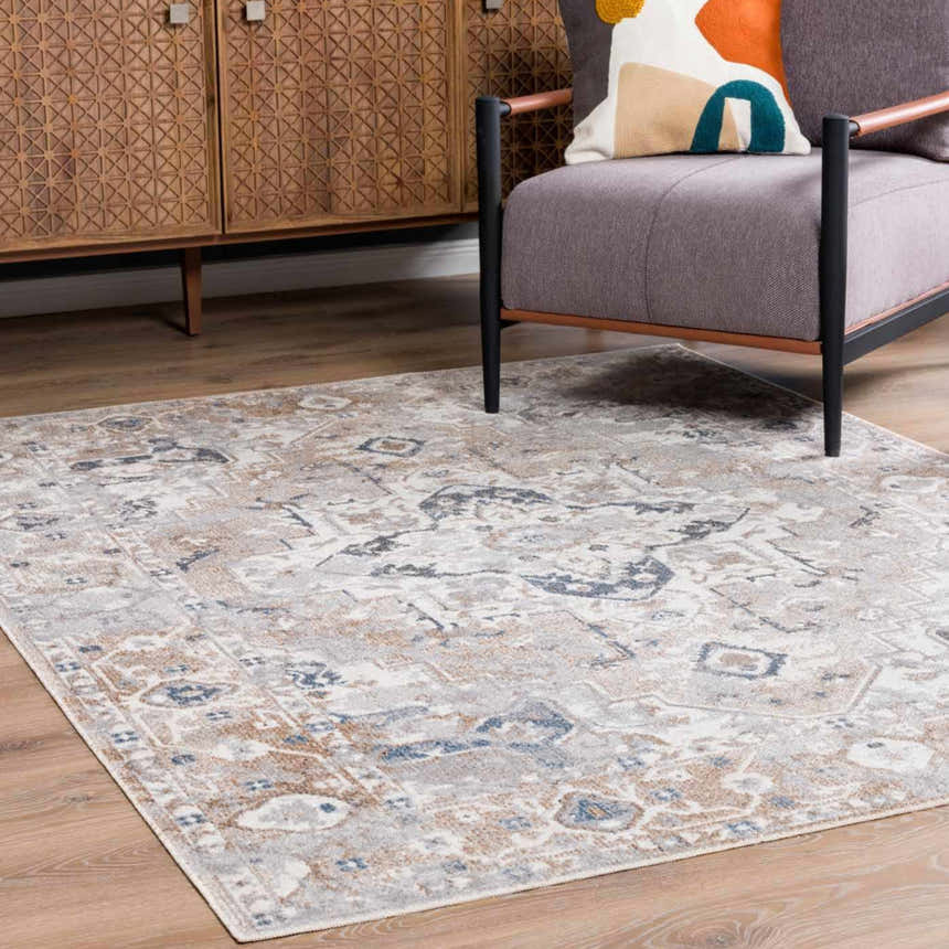 Living room scene with a gray chair and the blue, tan, and off-white Dobry Boutique Washable Rug. Roomscene-Rectangle