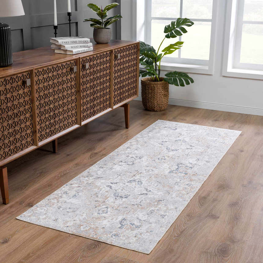 Entryway with a Dobry Boutique Washable Rug in blue, off-white, and tan, styled with a wood console table and plants. Roomscene-Runner