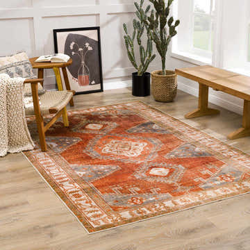 Living room scene with a Kullar Orange Washable Area Rug, wooden chair, bench, and cactus plants for a cozy, bohemian feel. Roomscene-Rectangle