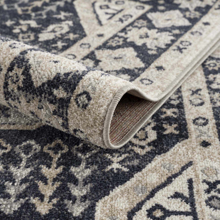 Close-up of the machine-woven Cabacungan Cream & Gray Washable Area Rug, showing its traditional, oriental-inspired pattern. Fold