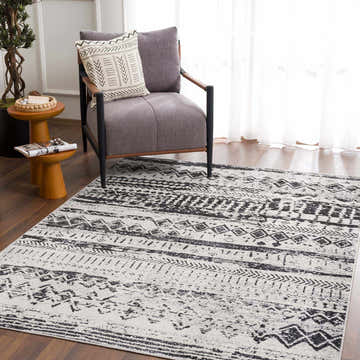 Living room scene with a gray chair on a black and light gray Lyssons Washable Area Rug. Roomscene-Rectangle