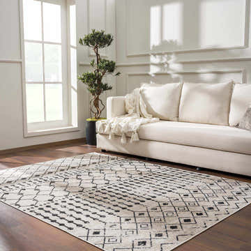 Living room with cream sofa and Joppatowne Washable Area Rug in black, cream, and beige geometric pattern. Roomscene-Rectangle