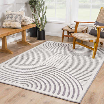 Bright living room with a gray and white geometric Deron Gray Rainbow Washable Rug. Roomscene-Rectangle