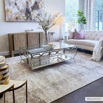 Living room scene with a Leeco Textured Luxe Rug, glass coffee table, and white sofa. Neutral tones and modern style. Roomscene-Rectangle