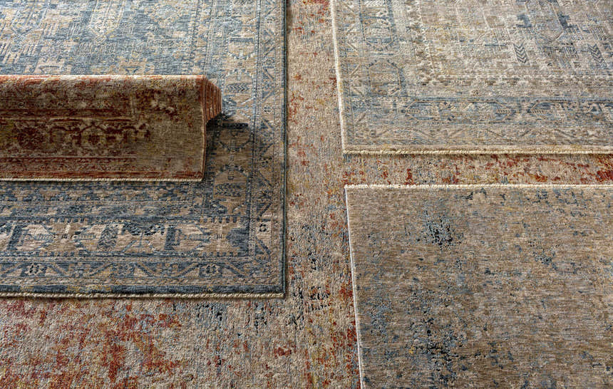 Close-up of Strathbogie Traditional Red Area Rug showing its brick red, cream, and blue bohemian-style pattern. Styleshot