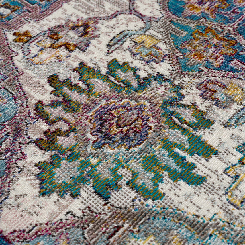 Close-up of the Mardin Colorful Area Rug, showing its blue, mustard, and purple oriental-inspired pattern. Texture