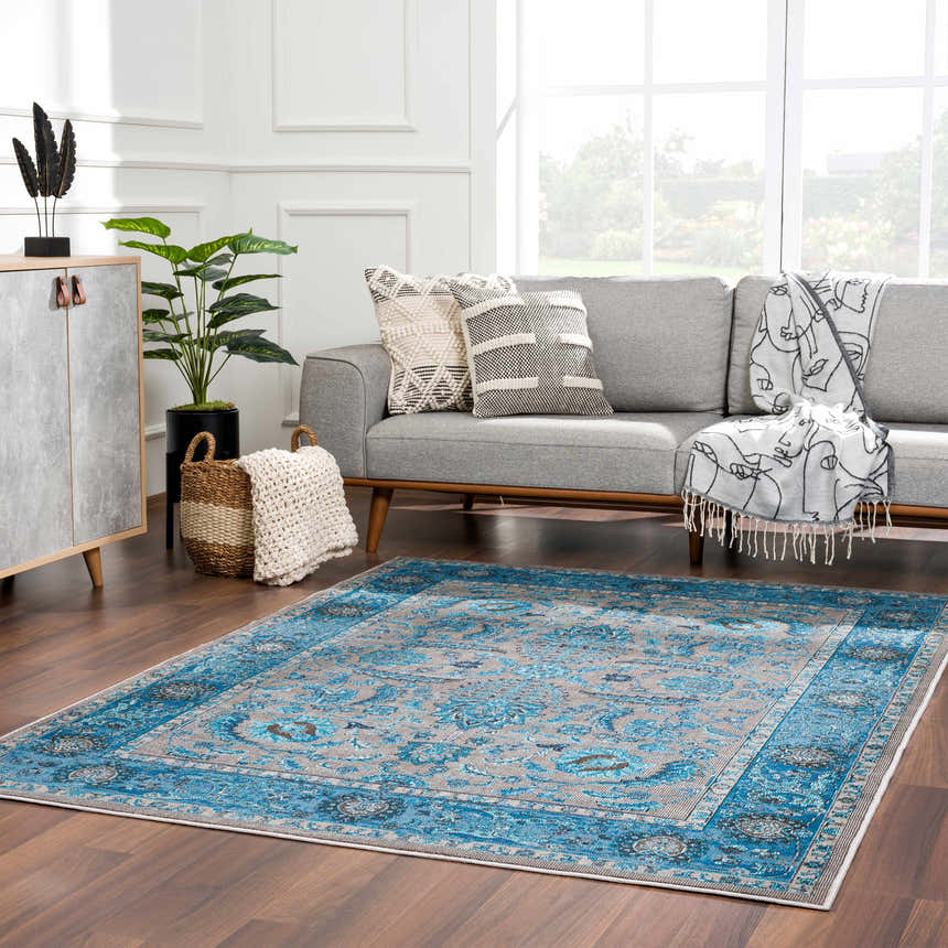 Living room with a Mardina Turquoise Area Rug, gray sofa, and modern decor. Roomscene-Rectangle