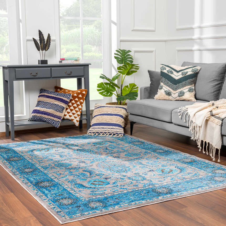 Living room scene with Mardina Turquoise Area Rug, gray sofa, console table, and decorative pillows. Roomscene-Rectangle