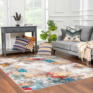Living room scene with gray sofa and Mardin Abstract Area Rug in blue, pink, mustard, and gray. Roomscene-Rectangle