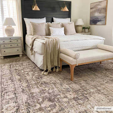 Bedroom scene with a Marlene Medallion Brown Area Rug, neutral bedding, and a dark wood headboard. Roomscene-Rectangle