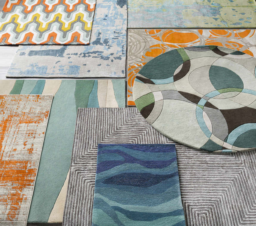 Assorted Jarratt Modern Wool Rugs in geometric, abstract, and striped patterns, featuring cream, green, gray, and orange hues. Styleshot