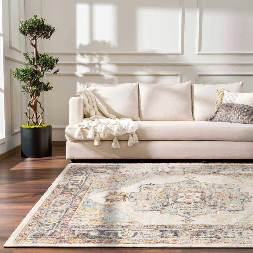 Living room with beige sofa, tree, and Hillcrest Area Rug in beige, blue, and red oriental pattern on dark wood floor. Roomscene-Rectangle