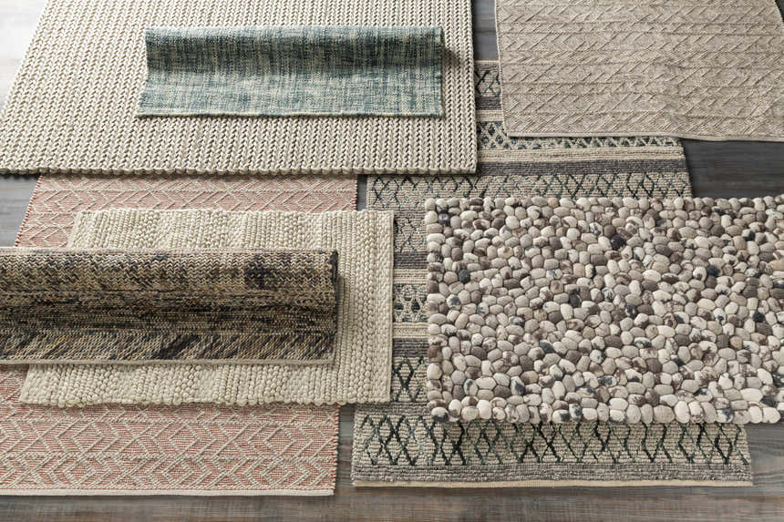 Variety of textures and patterns in Harlingen Area Rug styles: brick red, gray, light gray, hand woven rugs. Texture