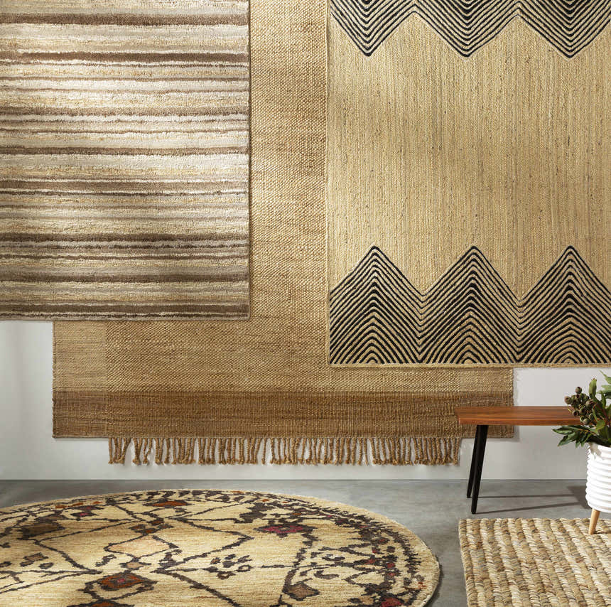 Styled room scene with Outaouais Jute Rug. Natural jute rugs in various patterns and textures on a white wall. Styleshot