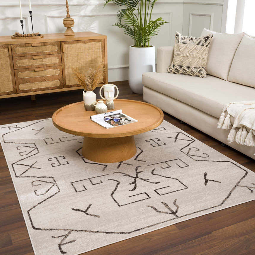 Living room scene with Azzan Cream & Charcoal Area Rug, wood furniture, cream sofa, and indoor plant. Roomscene-Rectangle
