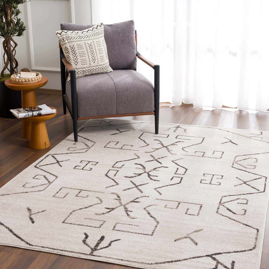 Living room scene with Azzan Cream & Charcoal Area Rug, gray chair, wood side tables, and hardwood floors. Southwestern style. Roomscene-Rectangle