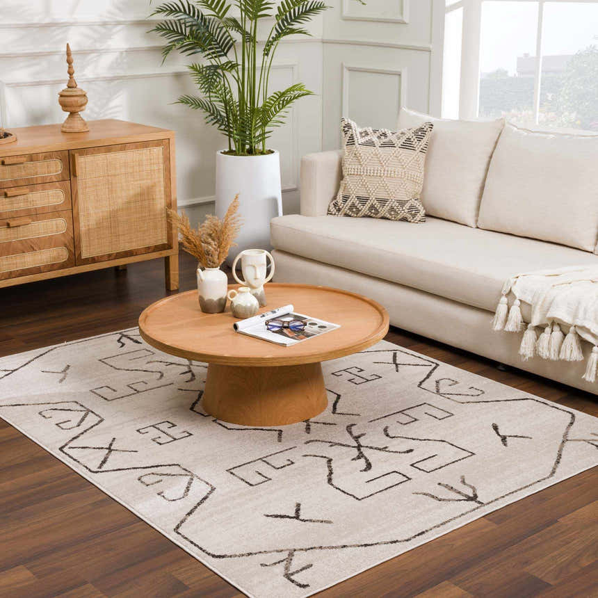 Living room scene with Azzan Cream & Charcoal Area Rug, cream sofa, wood coffee table, and natural decor. Roomscene-Rectangle