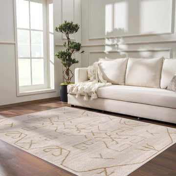Living room scene with a cream sofa and the Azzan Cream & Gold Area Rug on a dark wood floor. Roomscene-Rectangle