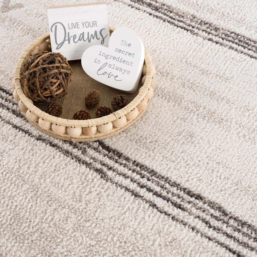 Close-up of Deja Cream & Charcoal Area Rug showing cream and charcoal stripes and soft texture. Scandinavian style. Styleshot