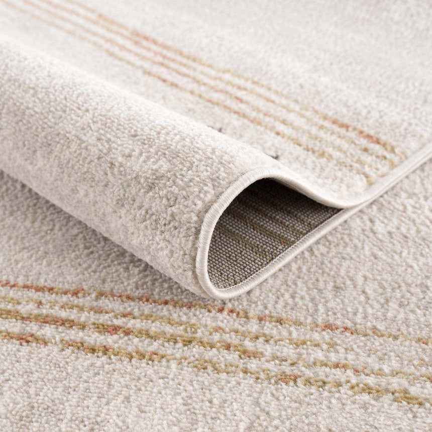 Close-up of the Deja Cream & Gold Area Rug showing its plush texture and subtle cream, gold, and trellis stripe design. Fold