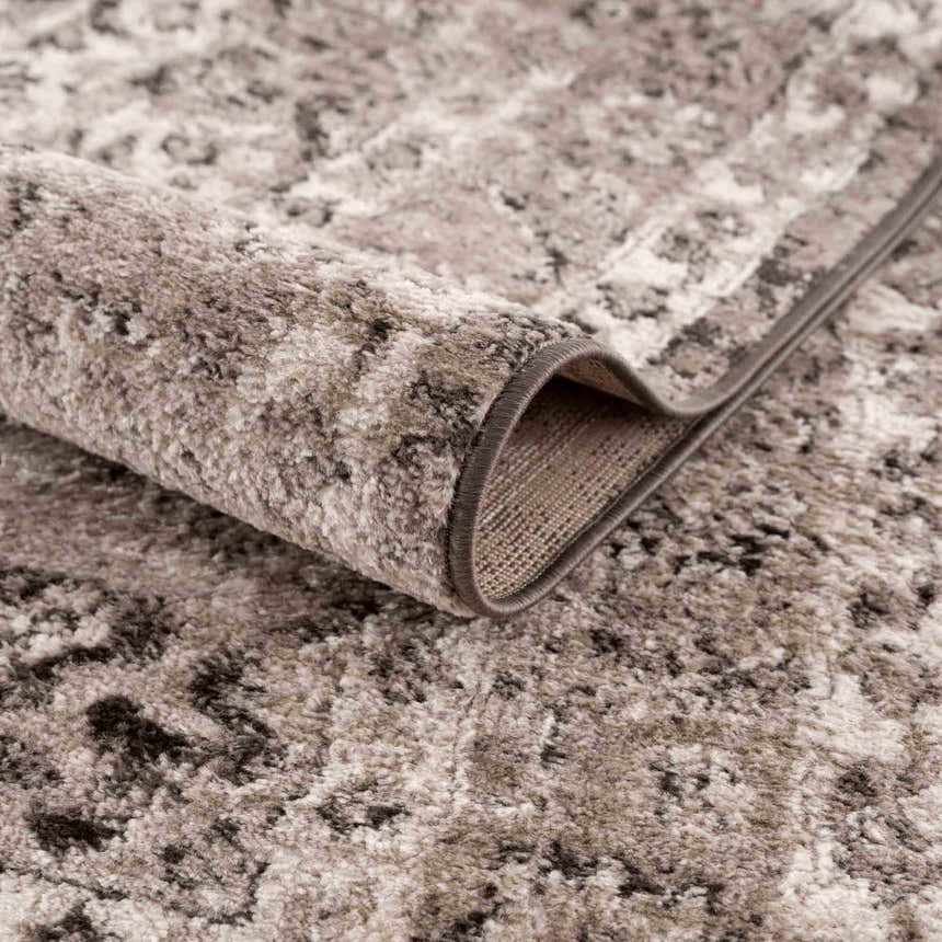 Close-up of the Albie Charcoal & Beige Area Rug showing its abstract pattern and soft, textured pile. Fold
