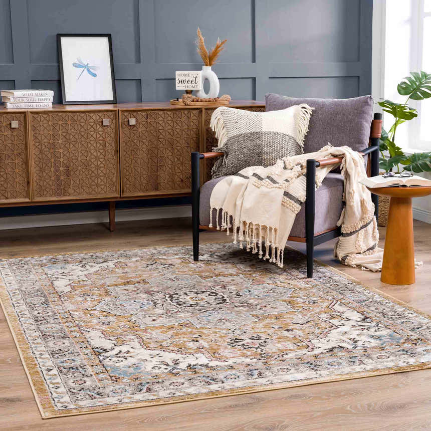 Living room scene with Albie Gold & Beige Area Rug, wood cabinet, gray chair, and neutral accents. Vintage style. Roomscene-Rectangle