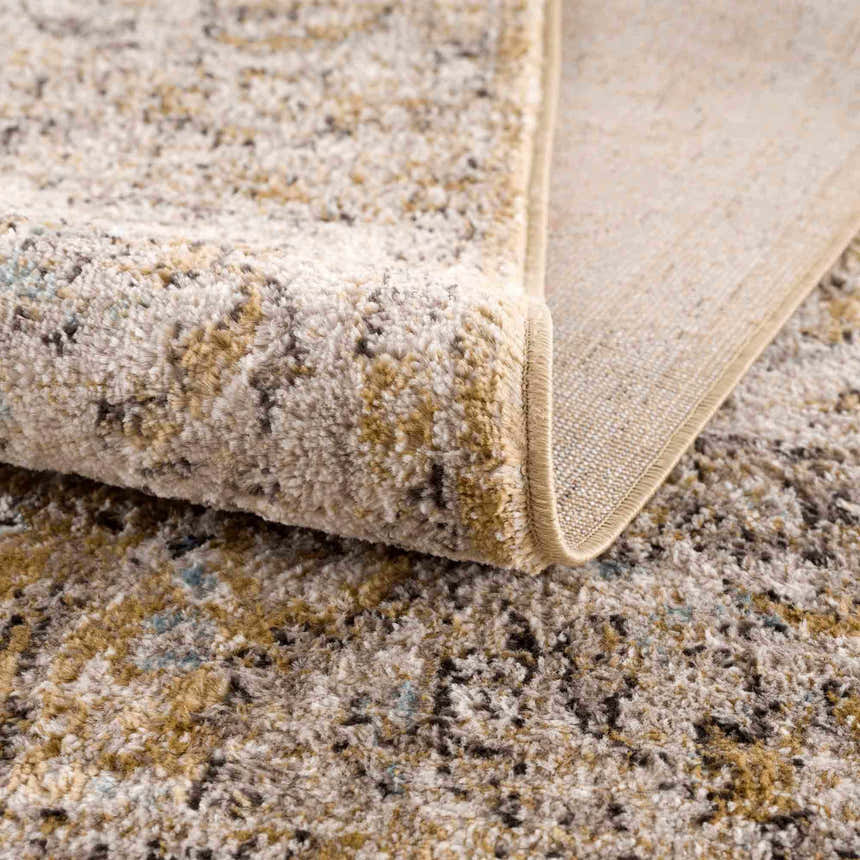 Close-up of the Anana Gold & Beige Area Rug showing its soft, textured pile and machine-woven construction. Fold