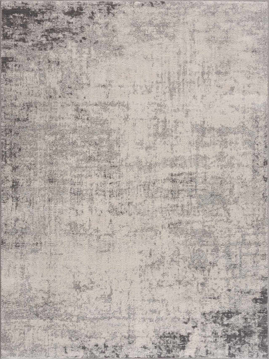 Close-up of the Kalanganan Abstract Gray Rug, featuring a distressed charcoal, gray, and off-white pattern. Design-Rectangle-5371