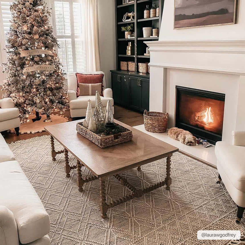 Living room scene with a Christmas tree and the ivory Ramsbury Wool Area Rug. Roomscene-Rectangle