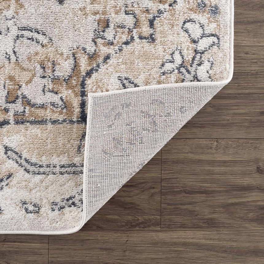 Close-up of the Mudgee Area Rug showing charcoal, cream, beige, and tan oriental-style pattern and the rug's backing. Fold