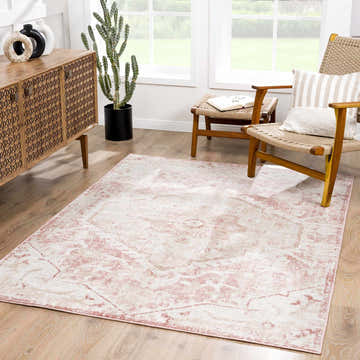 Living room scene with a cream and pale pink Leonora Area Rug, wooden cabinet, and woven chairs. Roomscene-Rectangle