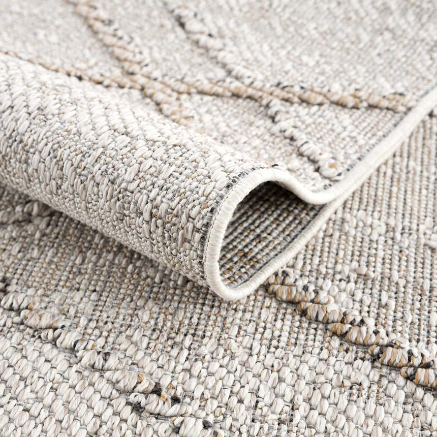 Close-up of the textured Baqer Bone & Tan Performance Rug showing its woven design and neutral color palette. Fold