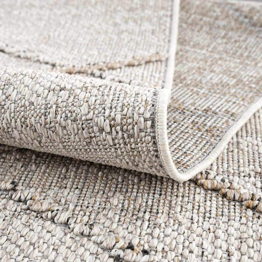 Close up of the Baqer Bone & Tan Textured Performance Rug showing the woven design and neutral color palette. Fold