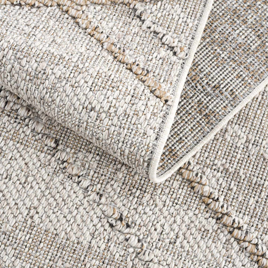 Close-up of the Baqer Bone & Tan Textured Performance Rug showing woven texture and pattern detail. Fold