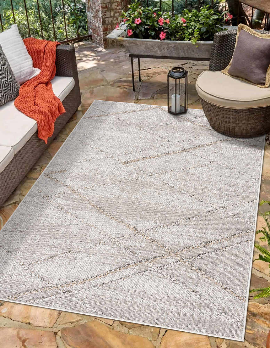 Outdoor patio scene with Baqer Bone & Tan Textured Performance Rug, wicker furniture, stone flooring, and neutral decor. Roomscene-Rectangle