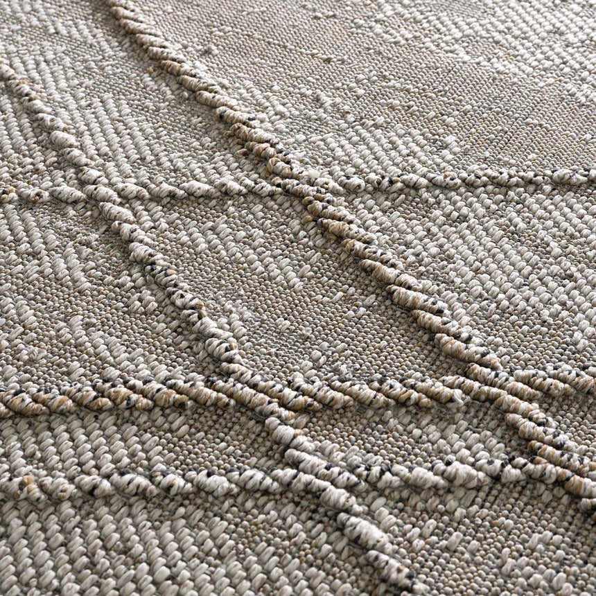 Close up of the Baqer Bone & Tan Textured Performance Rug, showing woven detail and neutral colors. Texture