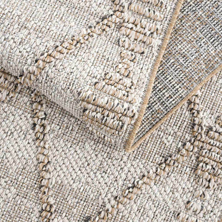 Close-up of the textured Nyla Bone & Tan Performance Rug, showing the woven design and neutral color palette. Fold