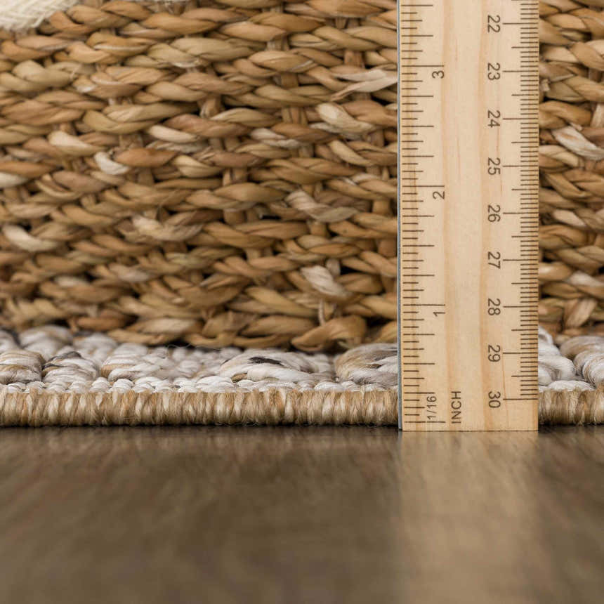 Close-up of the textured weave and pile height of the Nyla Bone & Tan Performance Rug. Pile
