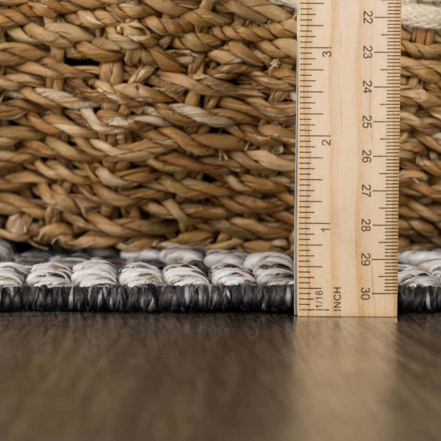 Close-up of the Diah Black & Bone Area Rug showing its texture, pile height, and black and bone color variations. Pile