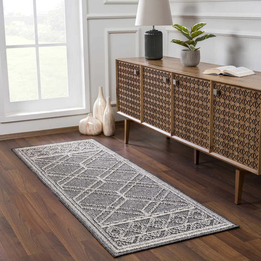 Entryway with Diah Black & Bone runner rug, wood floors, console table, vases, and natural light from a window. Roomscene-Runner
