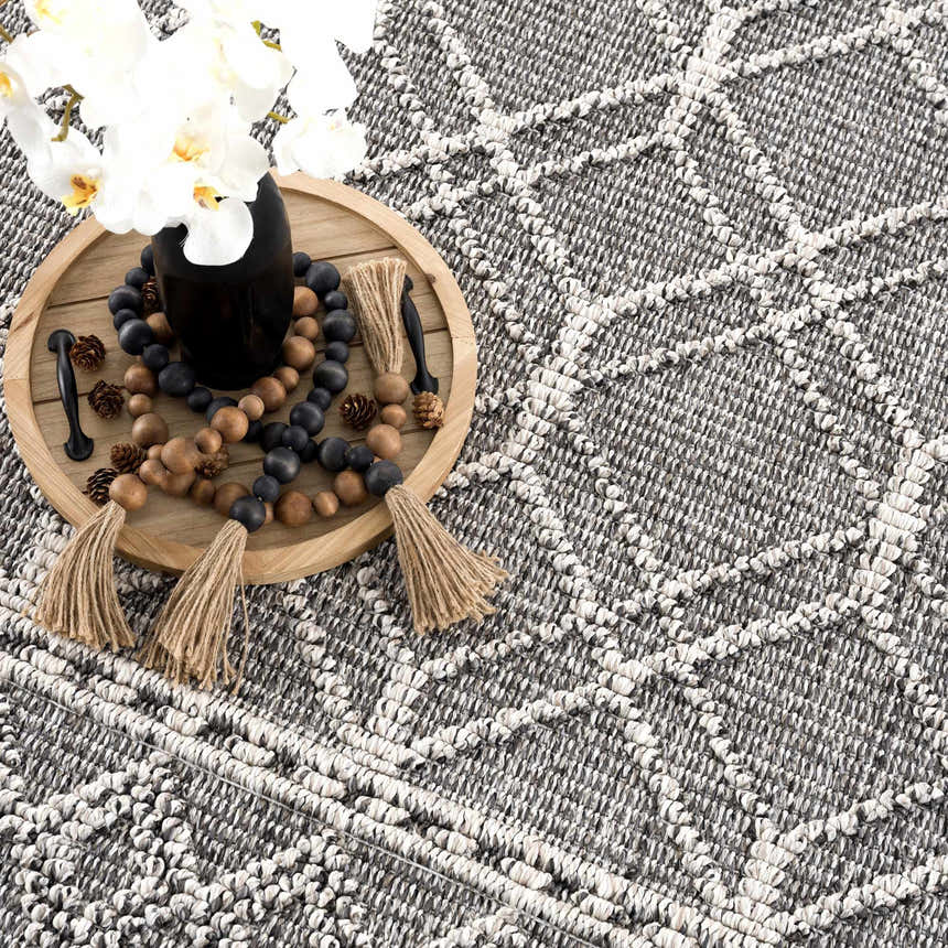Close-up of the Diah Black & Bone Area Rug showing its textured, geometric design and black and bone color palette. Styleshot