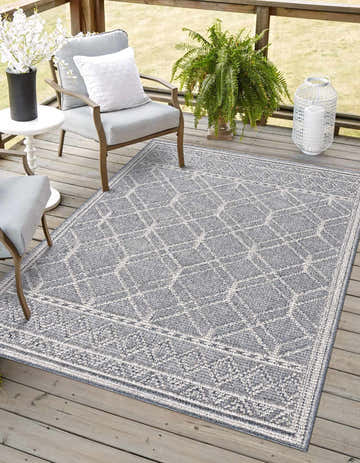Outdoor patio scene with Diah Gray Blue & Bone Area Rug, gray chairs, and wood deck. Roomscene-Rectangle