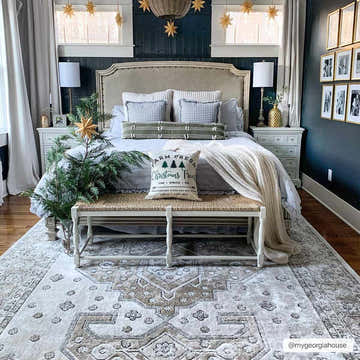 Bedroom scene with beige and charcoal Southwark Area Rug, woven bench, and Christmas decor. Roomscene-Rectangle