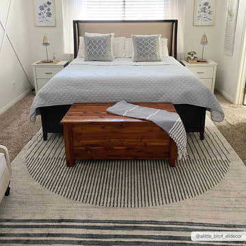Bedroom scene with Thad Medium Gray Washable Area Rug, wood chest, gray bedding, and white nightstands. Contemporary style. Roomscene-Rectangle